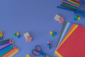colorful school supplies on a blue background