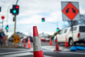 Orange traffic cones lining up roads at intersection. Roadworks in Auckland.