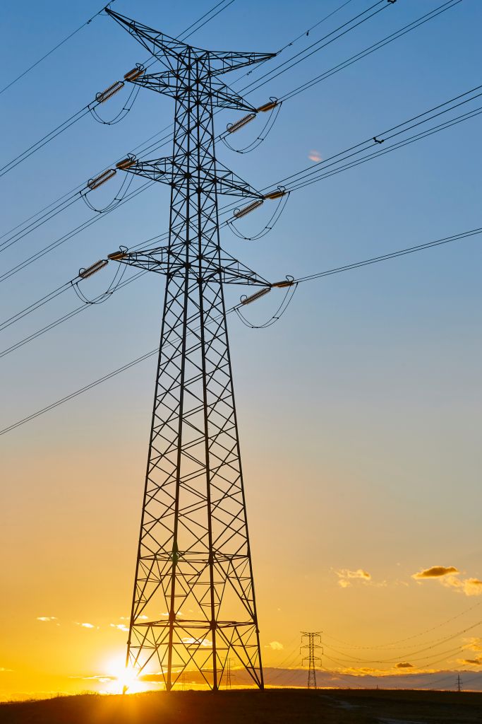 Power lines at sunset. Energy industry. Electricity distribution. Renewable production