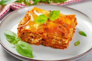 Delicious Homemade Lasagna with Bolognese Sauce on Bright Background, Italian Cuisine, Tasty Baked Lasagna
