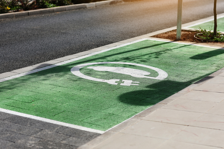 Special place for charging electric cars or vehicles. Green E- Car charging station sign in a parking bay. Modern and eco-friendly mode of transport that has become widespread in Europe, Spain.