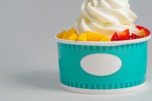 Close up of a vanilla soft ice cream with strawberry and mango.