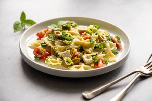 Pasta salad. Traditional Italian pasta with cherry tomatoes, olives, feta cheese, green lettuce