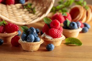 Small tartlets with fresh raspberries and blueberries.