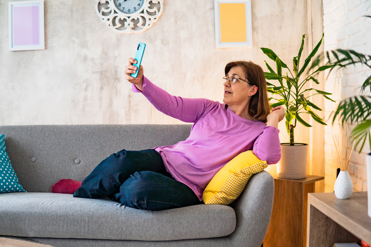 Senior woman taking a selfie at home