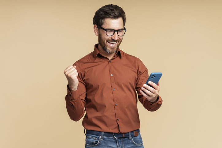 Emotional hipster using mobile app, sports betting, win money celebration concept