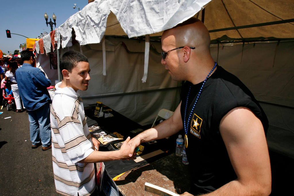 LATINO-RECRUIT_035_CG.JPG Sgt. Robert Marin, right, speaks with Julian Zaragosa, 18, of Oakland, at the U.S. Army's recruiting tent at the Cinco de Mayo festivities in the Fruitvale District of Oakland, Ca., on Sunday, May 7, 2006. Story is about sold