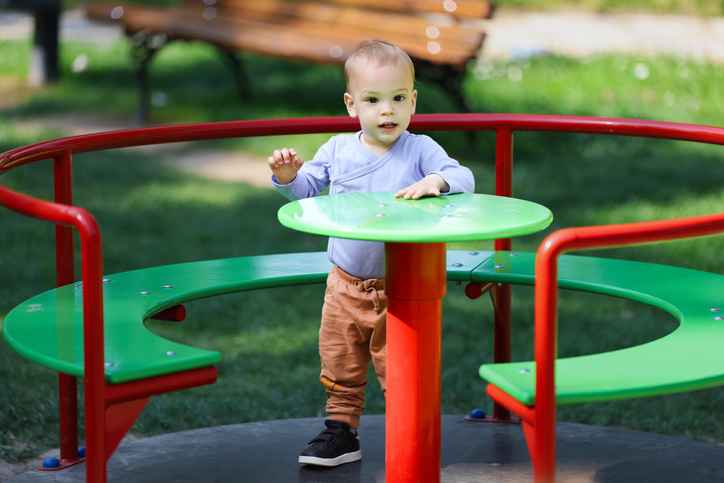 Cute boy in galxy wheel outdoors. Kids playing concept.