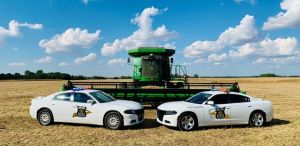 Photo of Police Cruisers and Farming Equipment