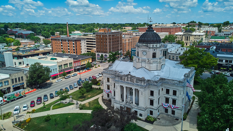 Aerial of downtown Courthouse in Bloomington Indiana with shops