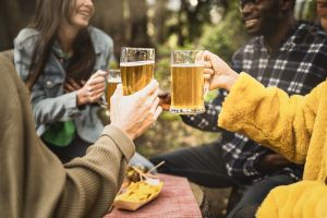 Best friends toasting with beers - crop shot