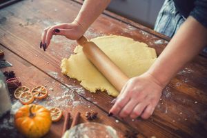 Woman preparing pumpkin pie for the holidays at home