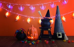 holidays image of Halloween. pumpkin and witch jars over wooden table