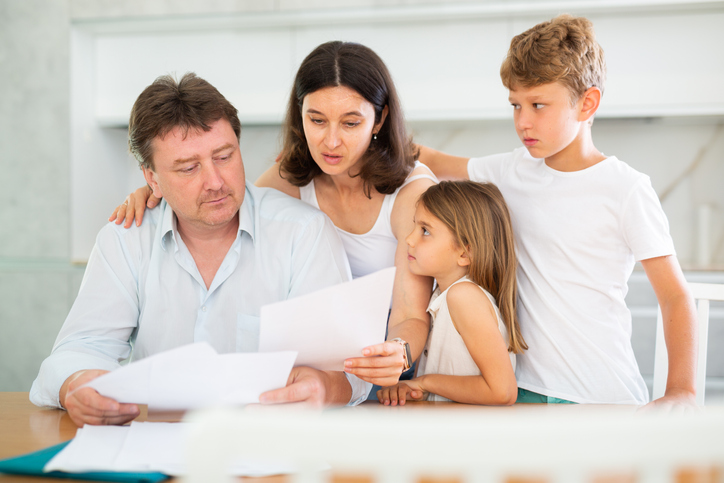 Sad family with documents having financial problems