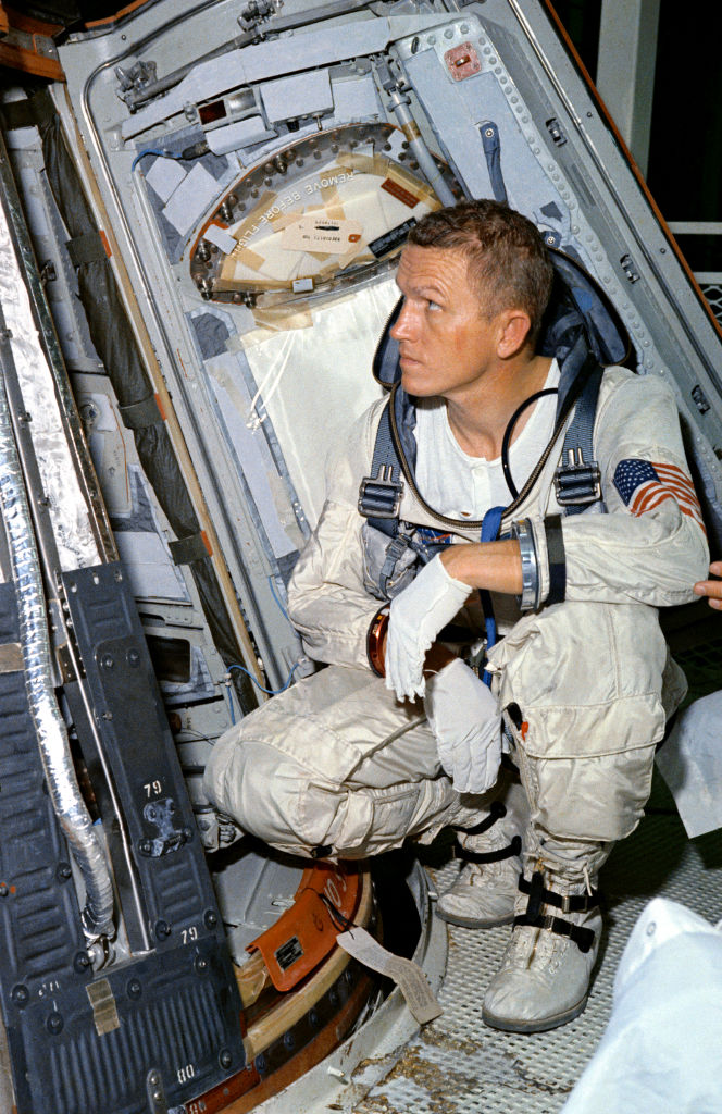 (25 Oct. 1965) Astronaut Frank Borman, command pilot for the Gemini-7 spaceflight, looks over the Gemini-7 spacecraft during weight and balance tests.