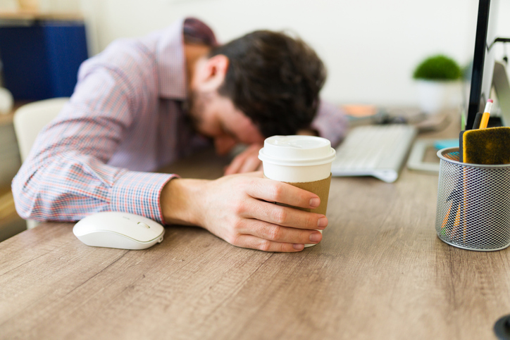Tired entrepreneur feeling sleepy and stressed at work