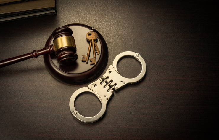 Gavel and handcuff with law books - court and justice theme