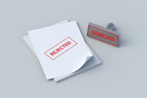 Word rejected on paper sheets near stamp. Claim denied. Unapproved financial loan. Insurance denial. Bad report. Refused agreement. Inappropriate contract. Censored episode. 3d render