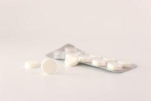 A pack of white pills on a white background. Medicine and health care.