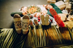 feet in warm knitted socks close-up Christmas at home