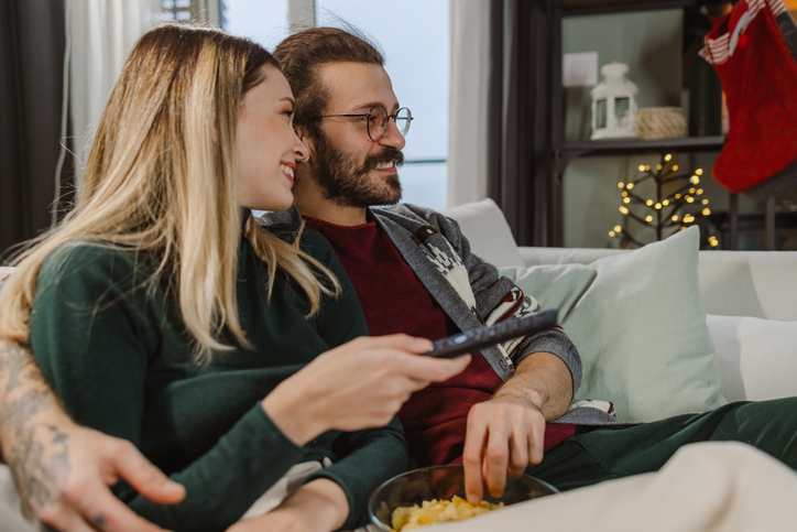 Couple watching favorite TV show during Christmastime