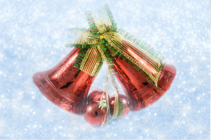 Christmas bells with bow on shiny background snowflakes