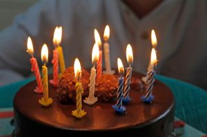 Colorful birthday candles on cake