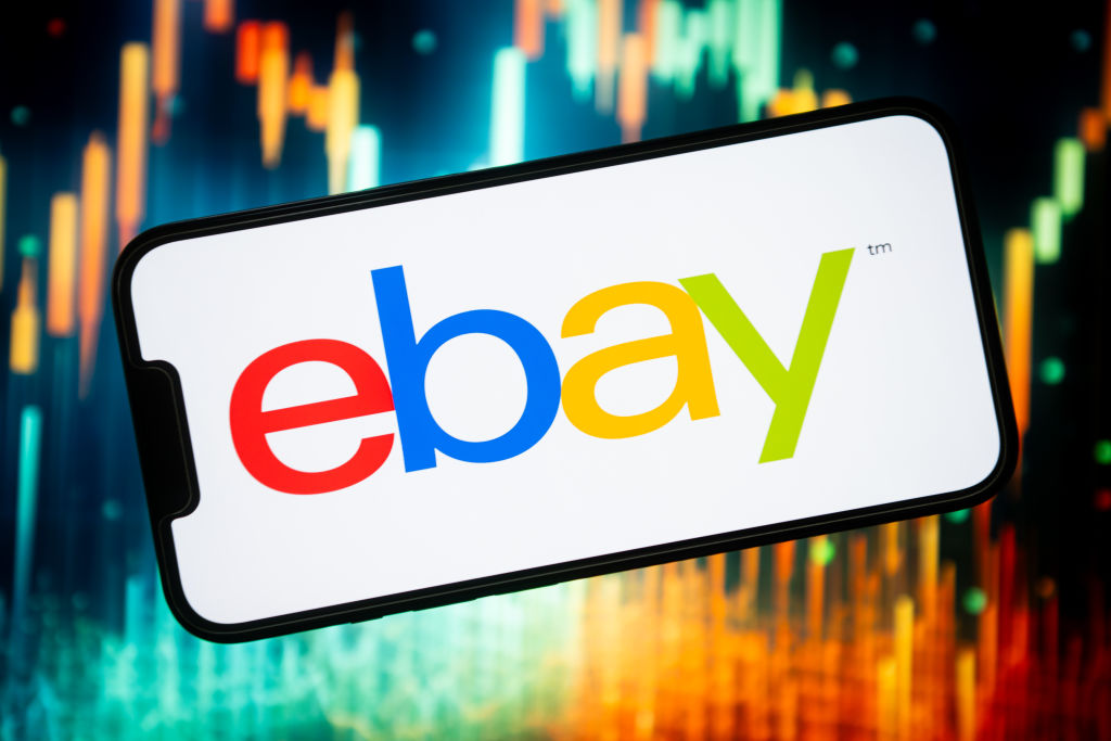 In this photo illustration, an Ebay logo seen displayed on a...