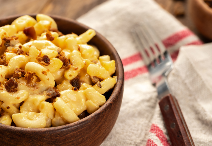 Bowl of macaroni and cheese with bacon pieces