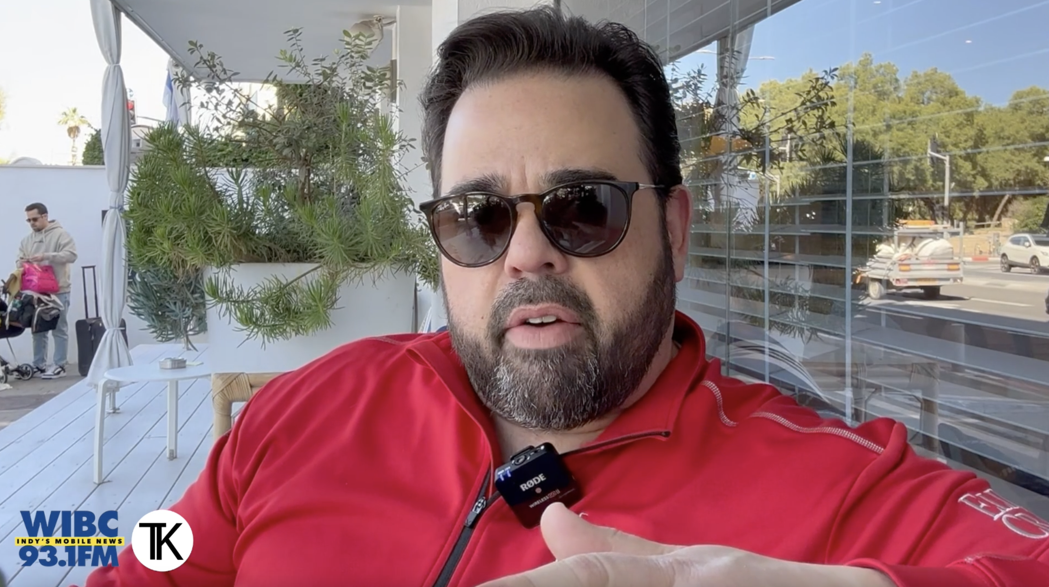 Tony Katz sitting in a chair outside a building while in Israel