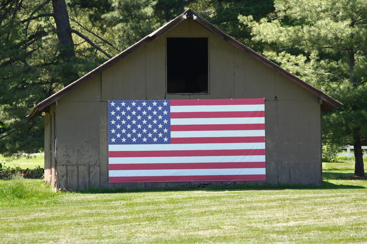 Barn with Big US Flag and mowed grass in Indiana