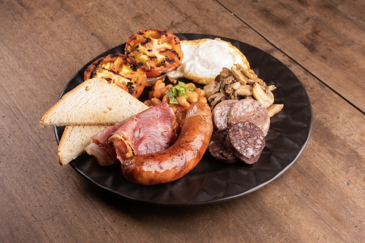 tasty breakfast english irish uk plenty of protein beans sweet sausage bacon egg mushrooms wooden table close up