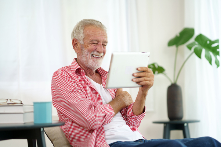 Senior adult uses technology to communicate with family and social network