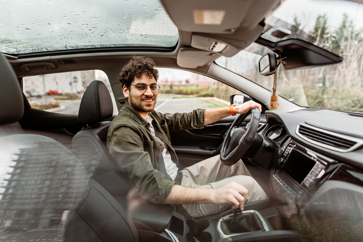Young businessman driving a car