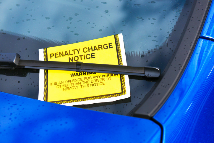 Parking ticket on blue car