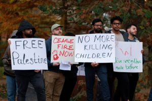 Protesters hold placards in Dunn Meadow at Indiana...