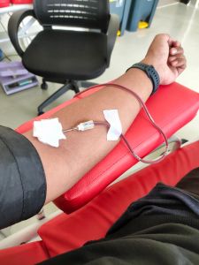 Arms of a blood donor with equipment and copy space.