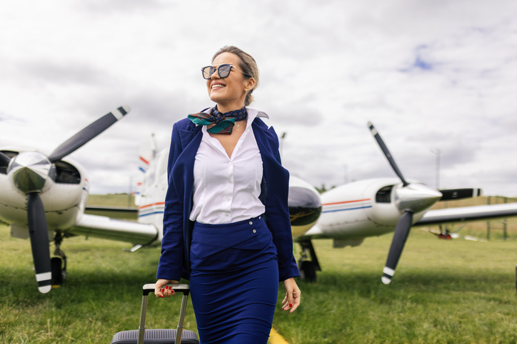 Stewardess in front of an airplane