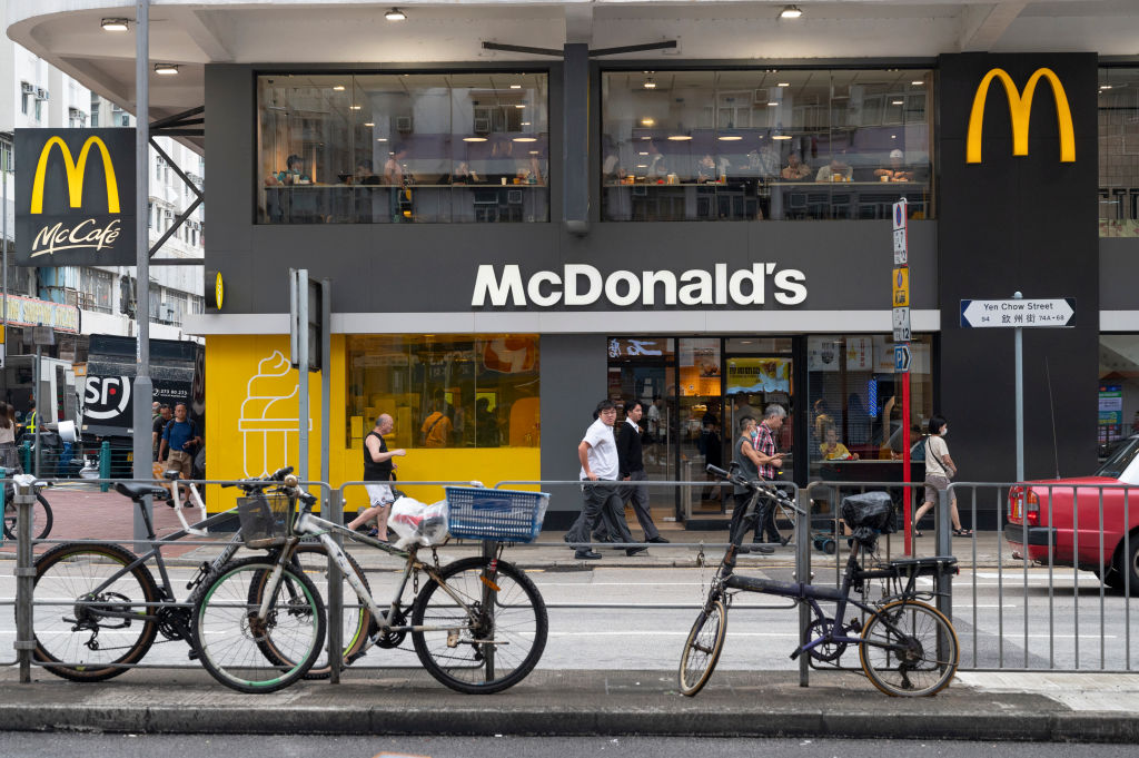 Pedestrians walk past the American multinational fast-food...