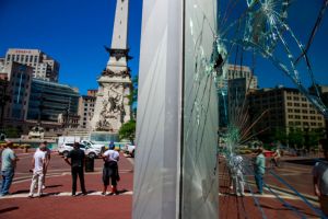 Pedestrians walk past smashed windows in the Salesforce...