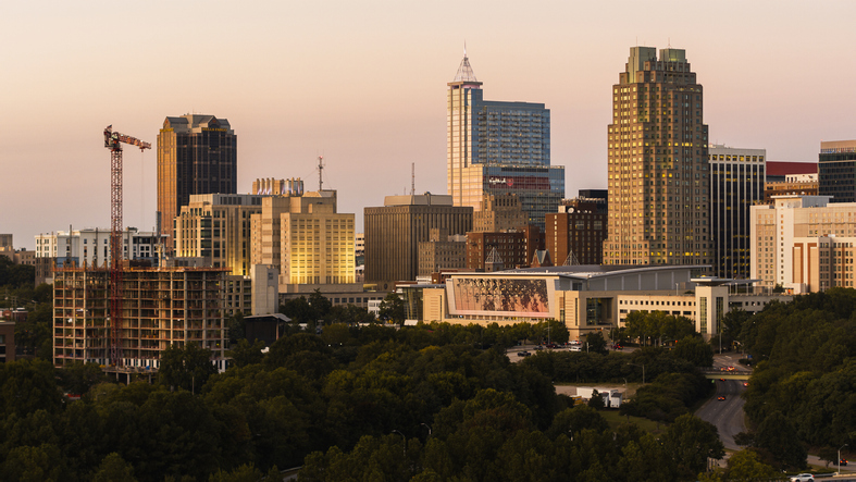 Raleigh, NC golden horizon: sunset bathes the construction site and Downtown skyline of Raleigh, North Carolina.