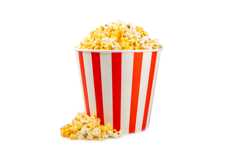 Tasty popcorn in color background. Cinema and entertainment concept. Movie night with popcorn.Cheese and caramel popcorn. Delicious appetizer, snack. Place for text. Copy space.Banner