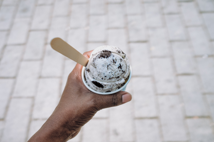 Woman Holds a Cup of Cookies and Cream Ice Cream