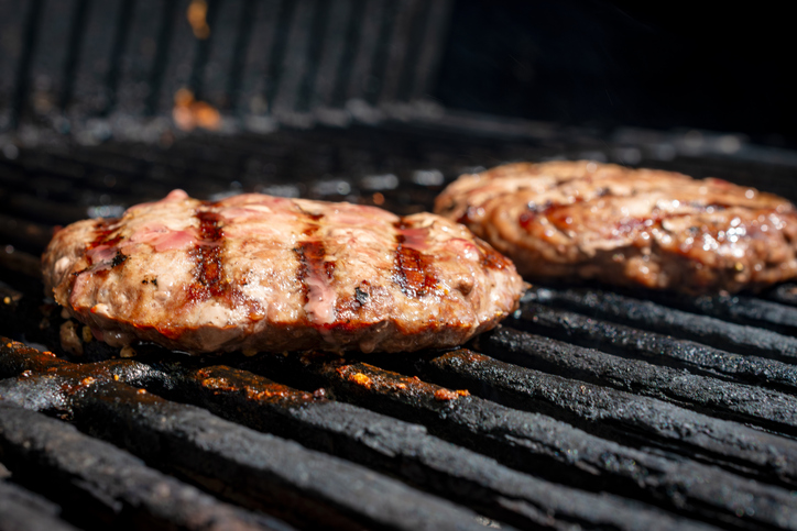 Homemade burger patty on a gas grill. Ready to eat.