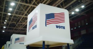 Voting booth with American flag logo at polling station