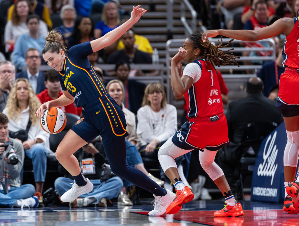 Katie Lou Samuelson of the Indiana Fever Tries to Collect the Ball as Ariel Atkins of the Washington Mystics Defends During the First Half