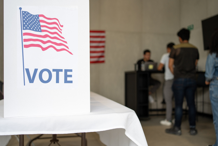 diverse group of people waiting in queue registration line in the us election ready for voting