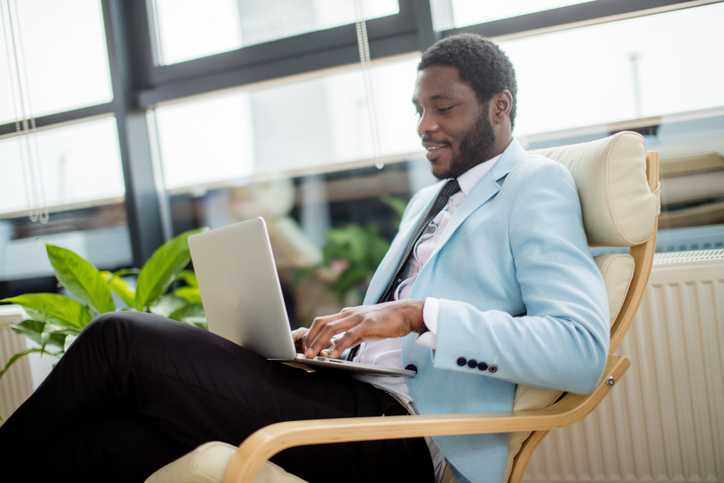 African american businessman in a business suit working on laptop