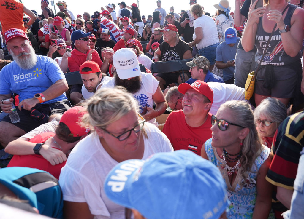 BUTLER, PENNSYLVANIA - July 13: Members of the crowd duck under