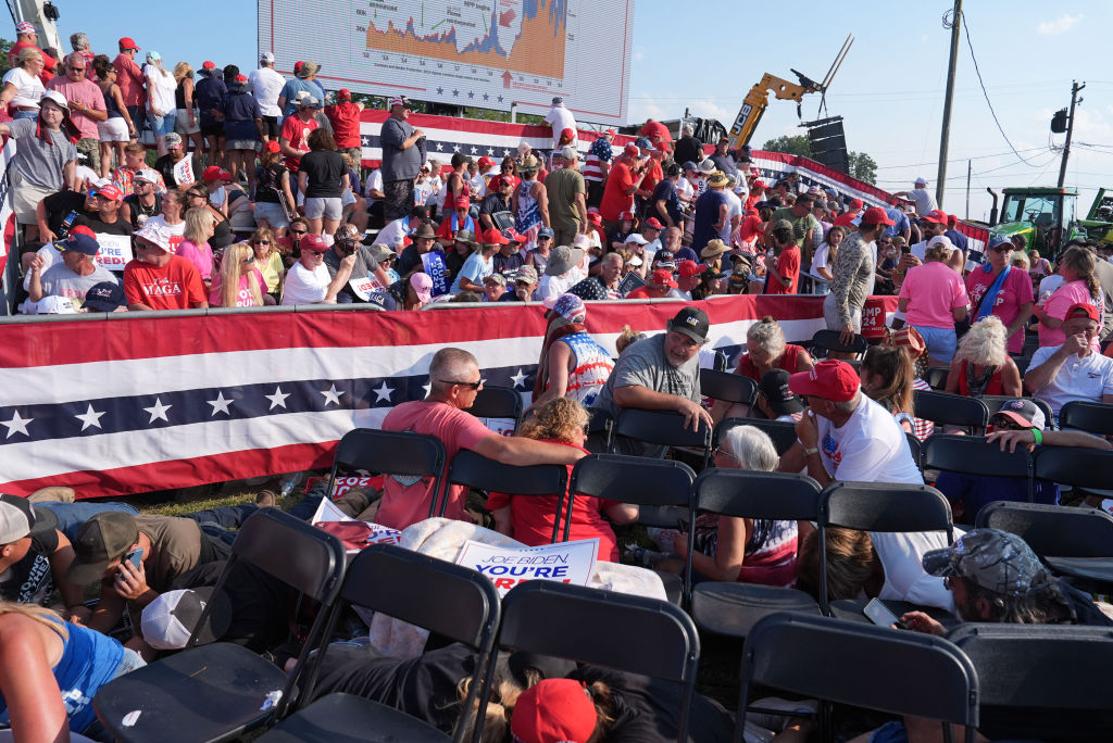BUTLER, PENNSYLVANIA - July 13: Members of the crowd duck under